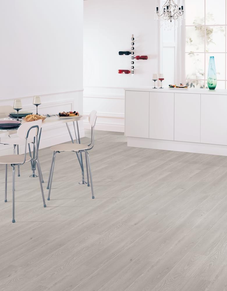 White kitchen with light wood flooring