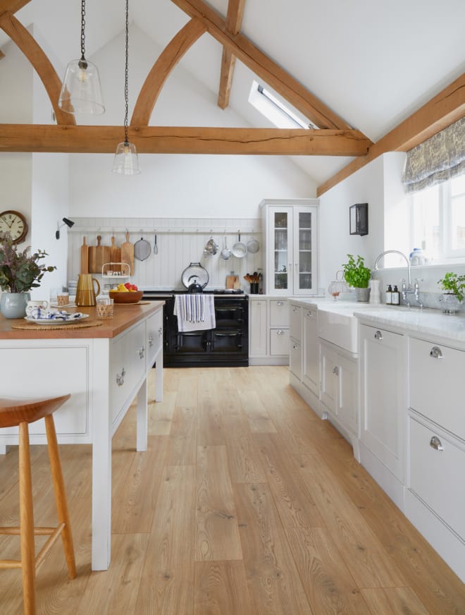 White kitchen with wooden flooring