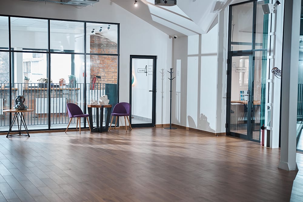 Modern empty office room with wooden floor